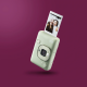 FUJIFILM Instax Mini LiPlay Matcha Green hybrid instant camera printing a selfie photo instantly with stylish pastel green finish and compact portable design